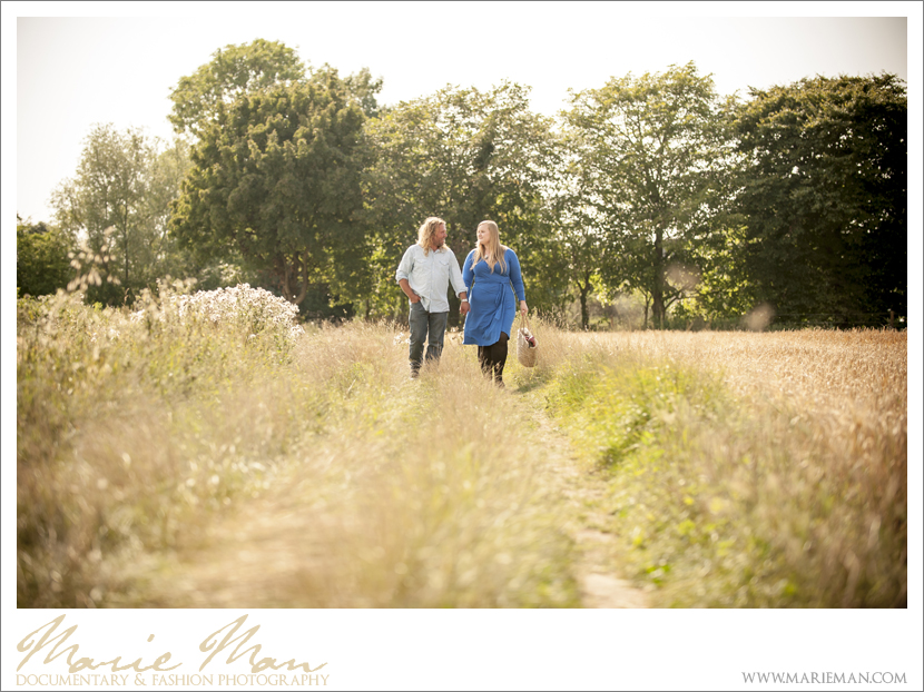 Emily & Paul - couple walking through a field of grass